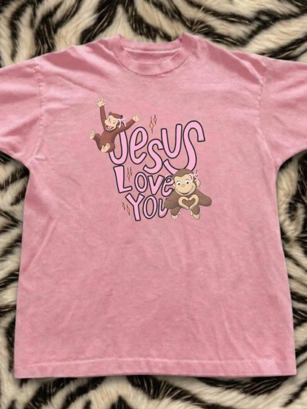 Light Pink Curious George Graphic with The Words " Jesus Love You"